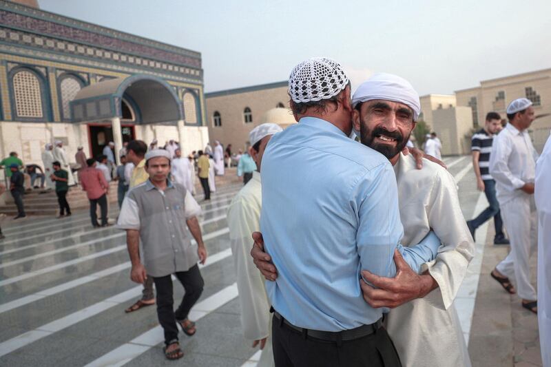 Abu Dhabi, U.A.E., August 21 , 2018.  Early morning prayers at the Masjid Bani Hashim mosque.  Friends great each other after early morning Eid prayers.
Victor Besa / The National
Section:  NA
Reporter:  Haneen Dajani