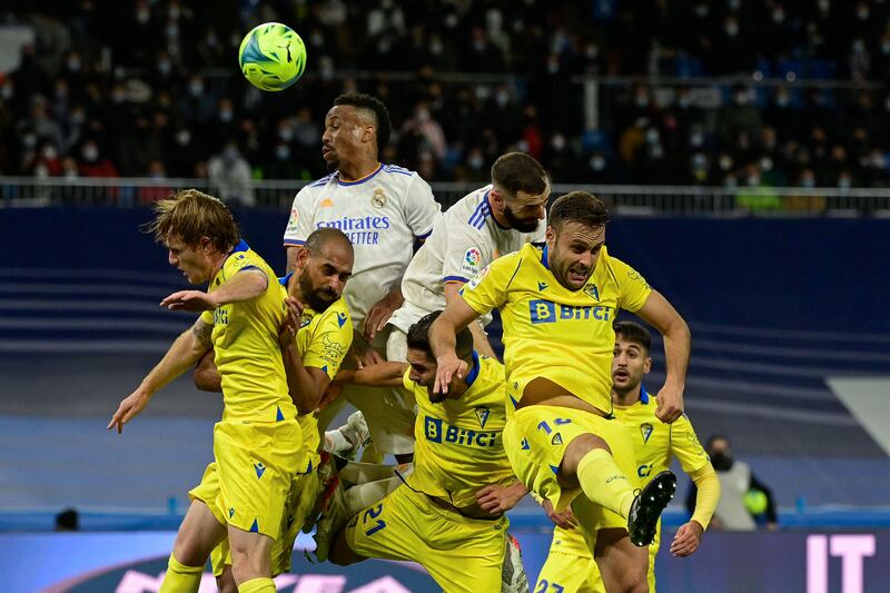 Real Madrid and Cadiz players challenge for a header. AFP
