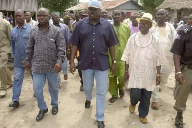 James Ibori, Governor of Delta State, Nigeria, tours a village to determine if ethnic Ijaw are sufficiently peaceful to allow oil production to resume in the western Niger Delta, 16 July 2003. Oil production in the area has been interrupted since March by ethnic unrest.