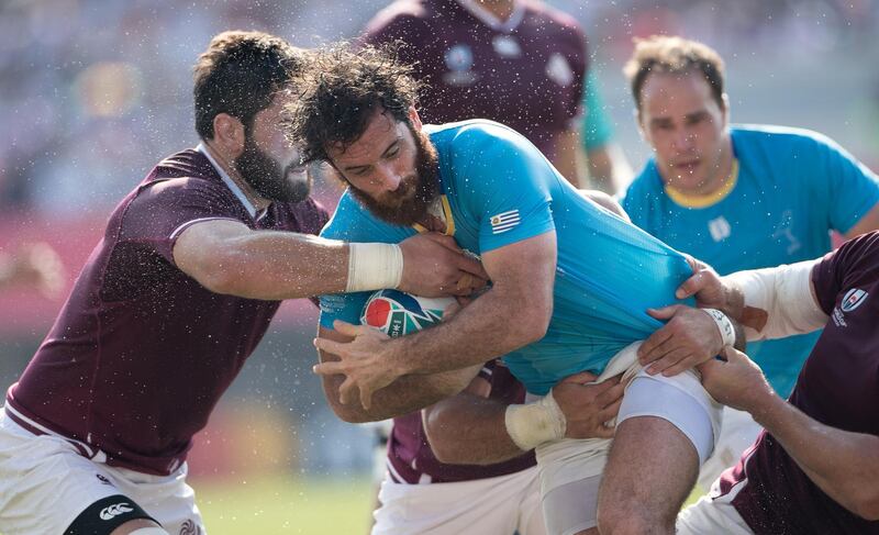 Uruguay wing Rodrigo Silva is tackled by the Georgia defence. Getty