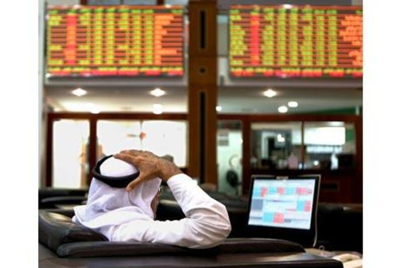 An investor monitors trading at the Dubai Financial Market. The index declined 4.6 per cent. Paulo Vecina / The National