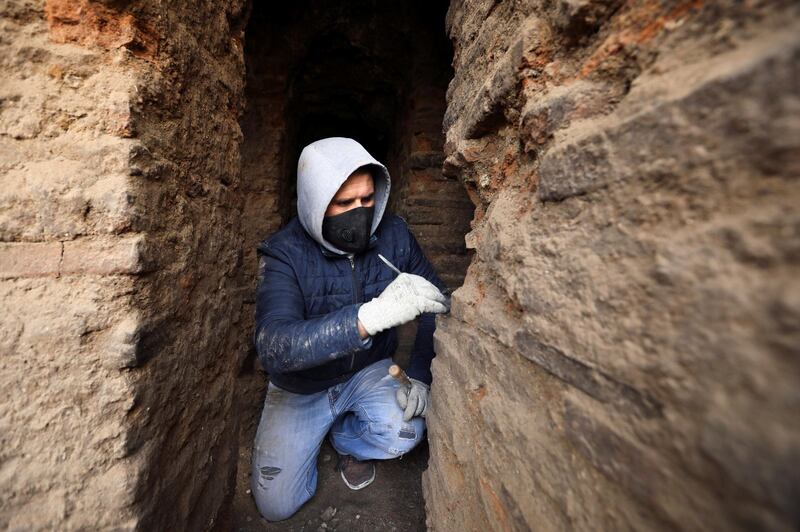 An archaeologist excavates at a Roman archaeological site discovered during works to install a water drainage system, in downtown Amman, Jordan. Reuters
