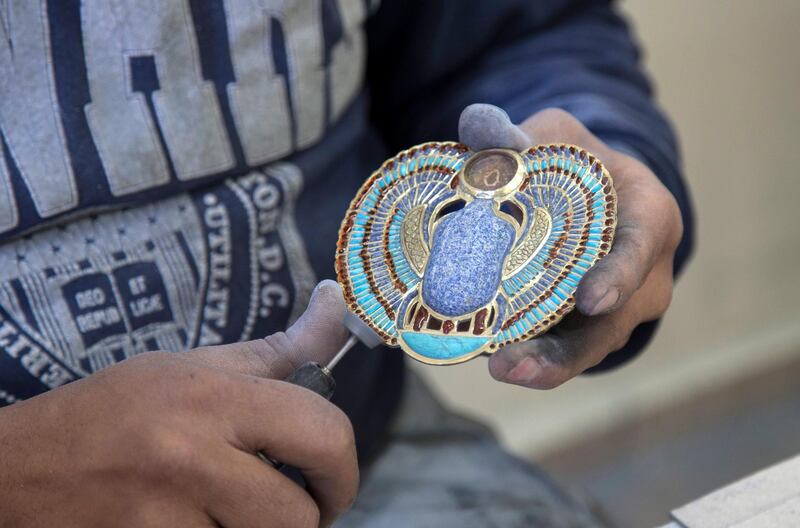 An artist prepares a replica of a Pharaonic piece at the Replica Production Unit located at Salah Al Din Citadel in Cairo, Egypt.  EPA