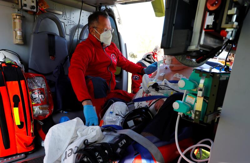 Doctor Simon Little of Johanniter air rescue attends to a patient with serious breathing problems prior to a flight from Gruenberg to a hospital in Bad Hersfeld, in Germany. Reuters