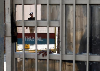 A policeman walks inside the Tihar Jail in New Delhi March 11, 2013. The driver of the bus in which a young Indian woman was gang-raped and fatally injured in December hanged himself in his jail cell on Monday, prison authorities said, but his family and lawyer said they suspected "foul play". Ram Singh, the main accused in India's most high-profile criminal case, killed himself in a cell he shared with three other inmates in New Delhi's Tihar jail just before dawn, prison spokesman Sunil Gupta said. REUTERS/Mansi Thapliyal (INDIA - Tags: CRIME LAW)