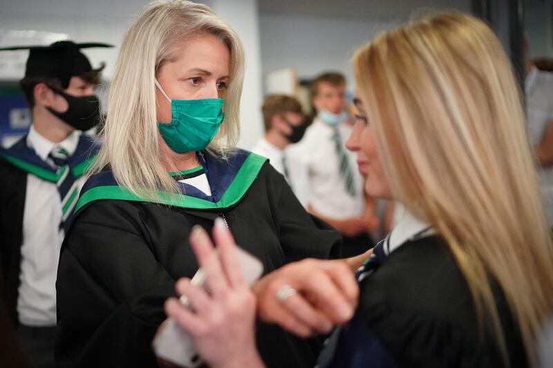 BBG Academy principal Saira Luffman helps a year 11 student prepare for their graduation prize giving ceremony in the school hall in Bradford, England. Getty Images