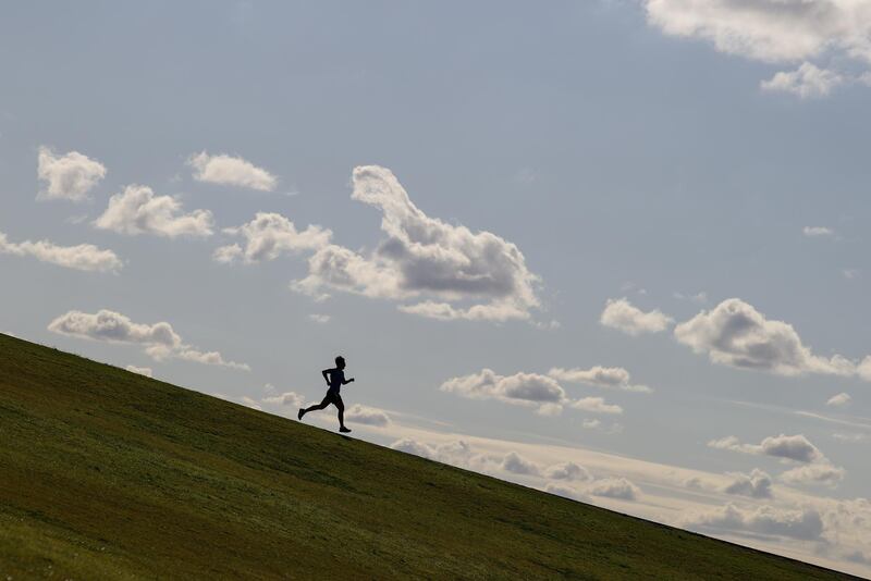 A runner exercises on a hill at Sydney Park, Australia. REUTERS