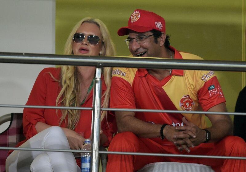Pakistani director and bowling coach of Islamabad United Wasim Akram, right, watches a match with his wife Shaniera Akram. Aamir Qureshi / AFP