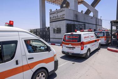 Ambulances evacuating injured Palestinians to Egypt for treatment arrive at the Rafah border crossing with the neighbouring country, in the southern Gaza Strip. AFP 