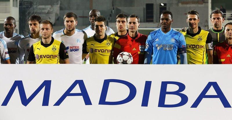 Borussia Dortmund and Marseille lined up before their Champions League match on Wednesday with a Mandela tribute sign. Sebastian Nogier / EPA