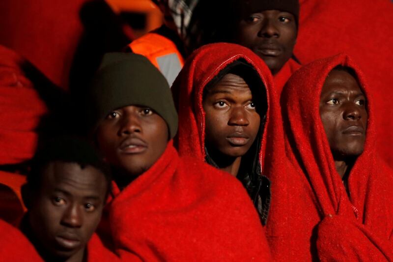 Migrants look on as they stand on a rescue boat in Malaga, Spain. Jon Nazca / Reuters