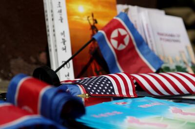 North Korean and American flags and books are displayed for sale at a stall outside the St. Regis hotel, where North Korean leader Kim Jong Un is staying in Singapore, on Monday, June 11, 2018. President Donald Trump is about to see whether his bet on North Korea will pay off: that Kim Jong Un’s desire to end his country’s economic strangulation and pariah status will prevail over the dictator’s fear of relinquishing his nuclear threat. Photographer: SeongJoon Cho/Bloomberg