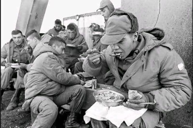 Argentine soldiers eat lunch after the invasion of the Falkland Islands in April 1982, an action that provoked the conflict with Britain that is commemorated in the book Falklands War Poetry. AFP