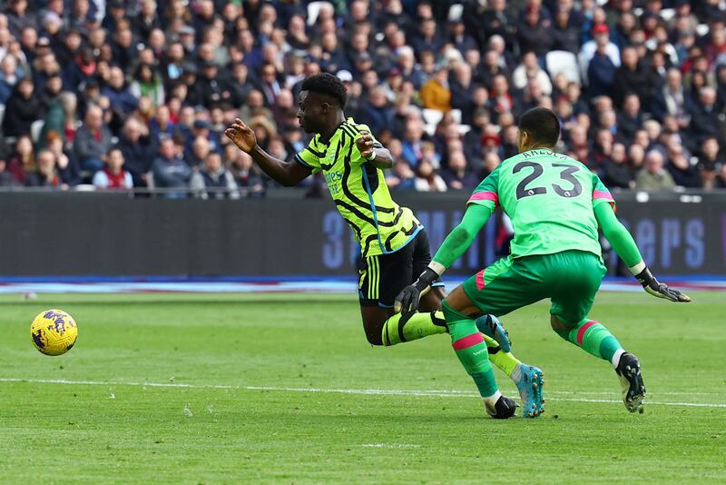 West Ham goalkeeper Alphonse Areola fouls Arsenal's Bukayo Saka to concede a penalty. Reuters