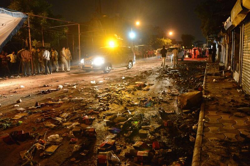 Indian police secure the site of clashes between two groups during which shops and vechiles were set alight in the Gomptipur area of Ahmedabad, India.  Sam Panthaky / AFP

