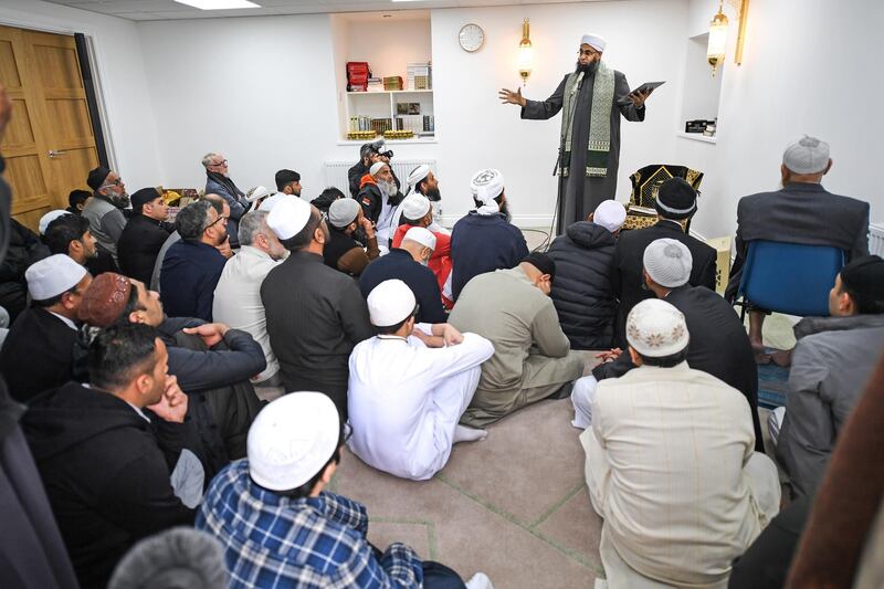 Members of the Muslim community listen to Iman Mufti Abdur-Rahman Mangera as they attend the opening of the first mosque built on the Western Isles, Stornoway, Scotland, on May 11, 2018. Jeff J Mitchell / Getty Images