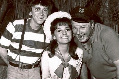 FILE - In this 1965 file photo, Dawn Wells, center, poses with fellow cast members of "Gilligan's Island," Bob Denver and Alan Hale Jr., in Los Angeles. Wells, who played the wholesome Mary Ann on the 1960s sitcom "Gilligan's Island," has died. Her publicist says Wells died early Wednesday, Dec. 30, 2020, in Los Angeles, of causes related to COVID-19. (AP Photo/File)