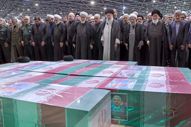 Mr Khamenei performs prayer at the funeral ceremony in Tehran. Reuters