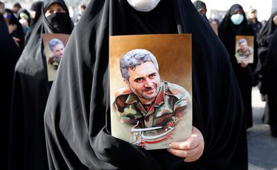 Women hold pictures of Iranian colonel Hossein Sayad Khodai during his funeral in Tehran in May. He was shot dead by unidentified gunmen outside his home in the south of the Iranian capital on May 22. Photo: EPA