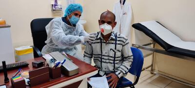 A doctor checks a patient at the Right Health clinic in Al Jurf, Ajman on Thursday. Workers are walking into low-cost clinics near their accommodation daily asking for treatment for fever and cough triggered by an awareness about the coronavirus outbreak. Doctors say such awareness among workers is required to catch cases early. Courtesy: Right Health