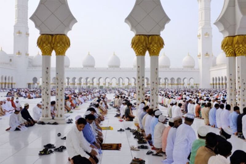 Worshippers pray the early Eid morning prayer at the Sheikh Zayed mosque in Abu Dhabi.