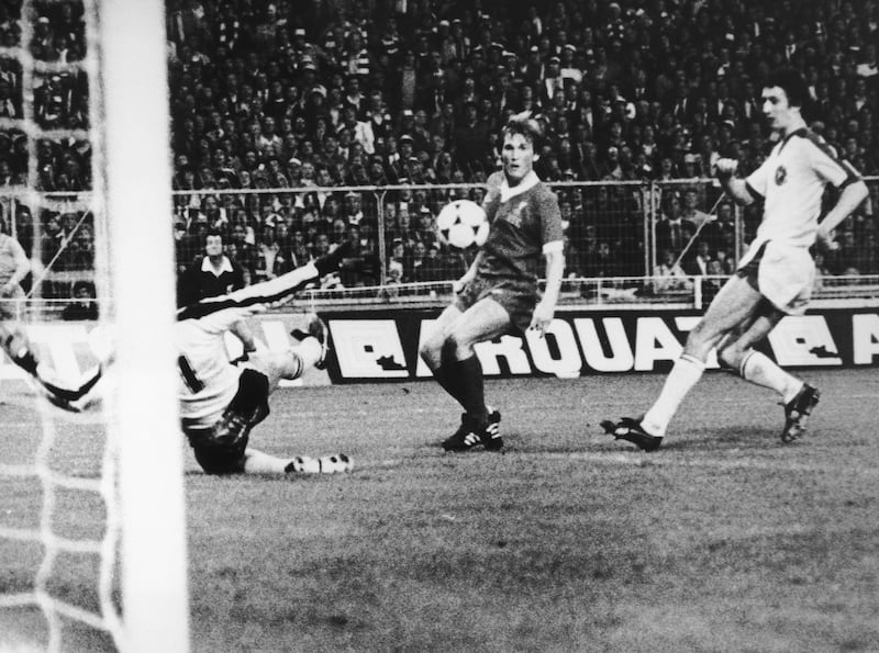 Kenny Dalglish of Liverpool watches apprehensively after chipping the ball past FC Bruges goalkeeper Birger Jensen in the European Cup final at Wembley, 11th May 1978. The shot was successful and won the match for Liverpool 1-0. 
(Photo by Central Press/Hulton Archive/Getty Images)
