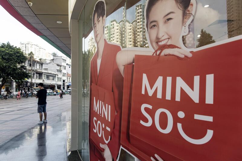A pedestrian stands outside a Miniso Group Holding Ltd. store in Guangzhou, China, on Thursday, Nov. 19, 2020. Miniso, the Chinese budget lifestyle goods retailer, is making its first foray into the $86 billion global toy market as it tries to take on heavyweights like Toys "R" Us Inc. on its home turf and beyond. Photographer: Qilai Shen/Bloomberg