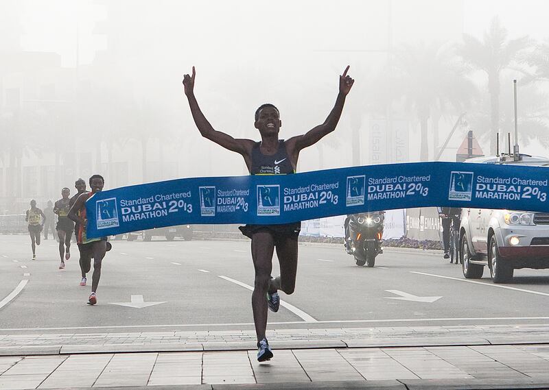 Dubai, United Arab Emirates, Jan 25 2013, 2013 Standard Chartered Dubai Marathon, - (centre) Elite runner Desisa benti Lelisa crosses the finish line at the Standard Chartered Dubai Marathon, Jan 25, 2013.  Mike Young / The National
