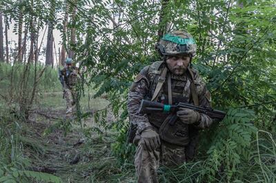 A soldier close to snipers in Serebryansky Forest, Ukraine. Getty