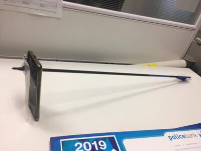 A picture shows an arrow that pierced a mobile telephone after accident in Nimbin, Australia March 13, 2019 in this picture obtained from social media on March 14, 2019.  NSW POLICE FORCE via REUTERS   ATTENTION EDITORS - THIS IMAGE HAS BEEN SUPPLIED BY A THIRD PARTY. MANDATORY CREDIT. NO RESALES. NO ARCHIVES.