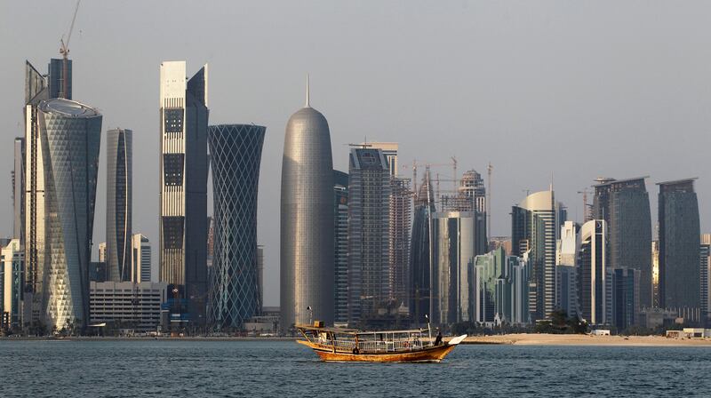 FILE - In this Thursday Jan. 6, 2011 file photo, a traditional dhow floats in the Corniche Bay of Doha, Qatar, with tall buildings of the financial district in the background. Qatar likely faces a deadline this weekend to comply with a list of demands issued to it by Arab nations that have cut diplomatic ties to the energy-rich country, though its leaders already have dismissed the ultimatum. (AP Photo/Saurabh Das, File)