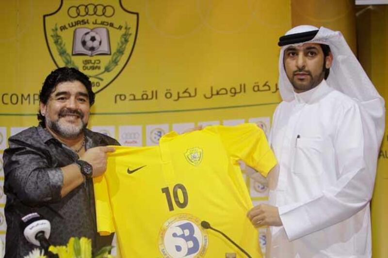 Happier times: Maradona, left, receives the new T shirt of the club, with Maradona's name and number 10 from Marwan bin Bayat, Chairman of Al Wasl Football club. Photo: AP Photo/Kamran Jebreili.