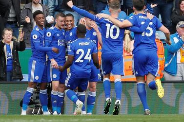Jamie Vardy, second left, is swamped by teammates after scoring his first and Leicester City's second goal against Arsenal. Reuters