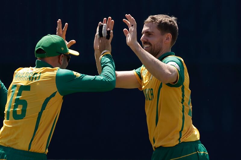 South Africa's Anrich Nortje, right, celebrates with teammate Keshav Maharaj after the dismissal of Sri Lanka batter Charith Asalanka. Nortje finished with figures of 4-7. AP