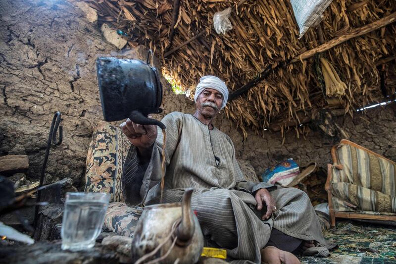 Ramadan Kamel, a 71-year-old Egyptian farmer, prepares tea as he rests in a shack by his farmland in the village of Baharmis in the countryside of Giza governorate, northwest of the capital Cairo. AFP