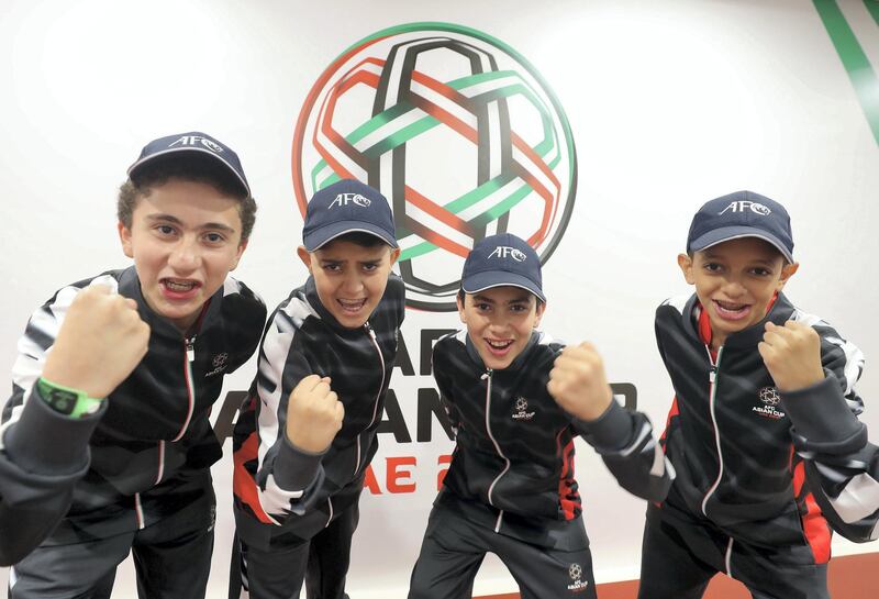 Abu Dhabi, United Arab Emirates - January 29, 2019: Flag carriers L-R Kareem Feras, Hisham Ahmad, Abdulmunem Mohamed and Belal Mohammed at the Asian Cup 2019. Tuesday, January 29th, 2019 at Mohamed Bin Zayed Stadium Stadium, Abu Dhabi. Chris Whiteoak/The National