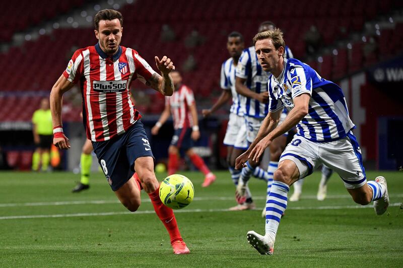 Atletico Madrid's Saul Niguez vies with Real Sociedad's Nacho Monreal. AFP