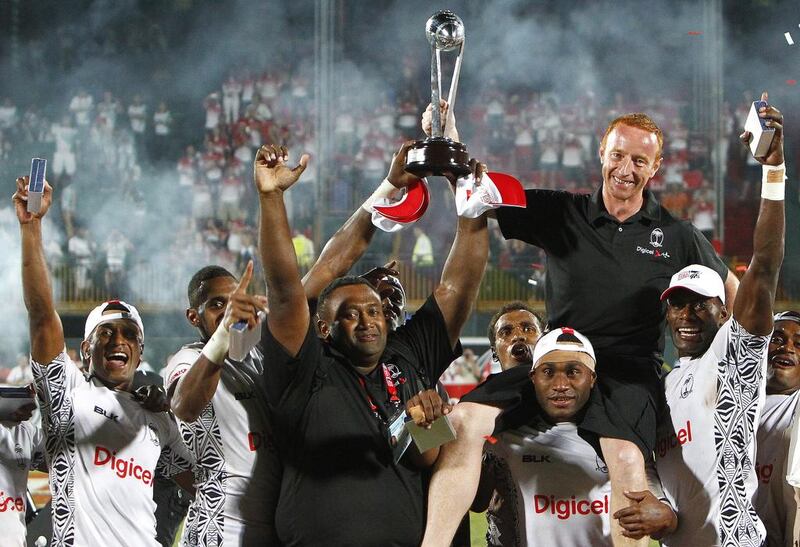 Coach Ben Ryan is hoisted by the Fijian team after they beat New Zealand in the cup final and won the Dubai Rugby Sevens last year. Jake Badger / The National

