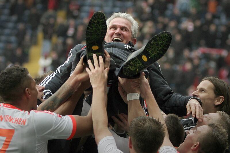 Munich's players hoist their head coach Jupp Heynckes into the air in celebration after the Bundesliga soccer match  between Eintracht Frankfurt and Bayern Munich at Commerzbank Arena in Frankfurt,  Germany, Saturday April 6, 2013. Bayern Munich wrapped up the German title in record time by winning 1-0 at Eintracht Frankfurt on Saturday with six rounds left in the season, an unprecedented feat in 50 years of the Bundesliga.   (AP Photo/dpa,Arne Dedert/picture-alliance/dpa/AP Images *** Local Caption ***  Germany Soccer Bundesliga.JPEG-07568.jpg