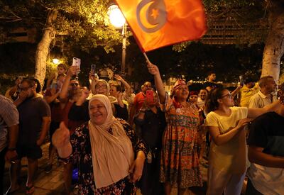 Supporters of president Kais Saied celebrate after an exit poll indicates voters backed new constitution in Tunis, Tunisia, 25 July 2022.  Tunisia is holding a referendum on a new draft constitution proposed by the Tunisian President to replace the 2014 Constitution.   EPA / MOHAMED MESSARA