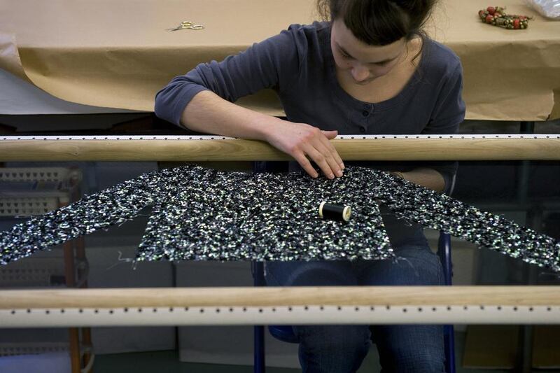 Using an embroidery sample validated by the studio, the fabric is mounted on a frame and the embroiderers at the Montex ateliers begin applying sequins, using the Lunéville technique; 181,000 sequins are required to complete the embroidery of the top, 77,000 sequins for the embroidery of the corset and 50,000 sequins for the underskirt. (Courtesy: Chanel)