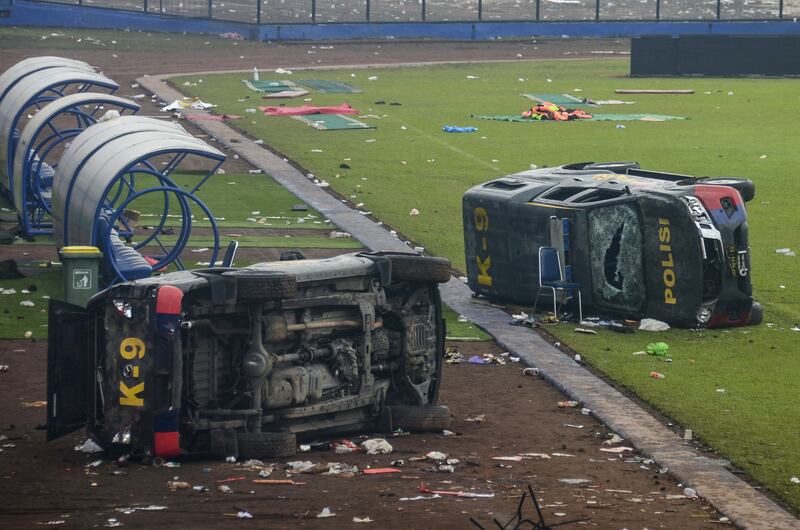 Damaged police cars at Kanjuruhan stadium in Malang,  Indonesia, after 127 people were killed following a stampede at a football match on October 2. EPA