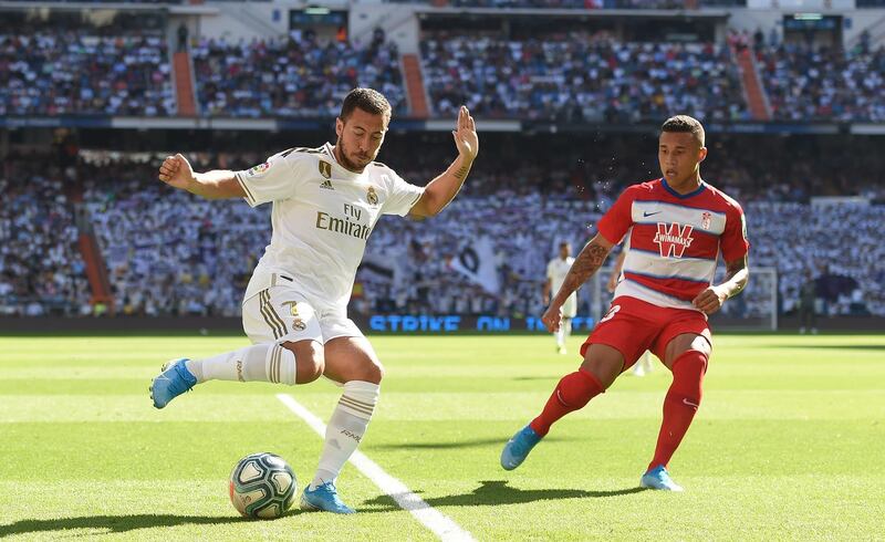 Eden Hazard of Real Madrid shields the ball from Darwin Machis of Granada. Getty
