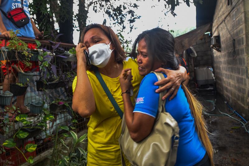 Relatives grieve the loss of loved ones after a fire broke out at an informal settlement inside the campus of the University of the Philippines. All photos: AFP