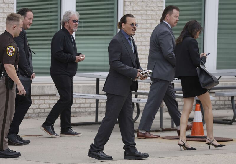 Depp and his team take a break during the trial at the Fairfax County Courthouse. Getty Images / AFP
