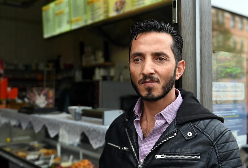 08 October 2020, Saxony-Anhalt, Halle (Saale): Ismet Tekin stands in front of his Kiez-DÃ¶ner in Halle/Saale during a demonstration of migrants. Under the motto "Now we are talking" one year after the right-wing terrorist attack on the synagogue and the kebab snack bar, the participants want to set an example, talk about their perspectives, experiences and dreams. Photo: Hendrik Schmidt/dpa-Zentralbild/dpa (Photo by Hendrik Schmidt/picture alliance via Getty Images)