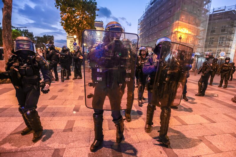Riot police secure the area in front of the Arc de Triomphe amid fears of another night of clashes with protestors in Paris. EPA