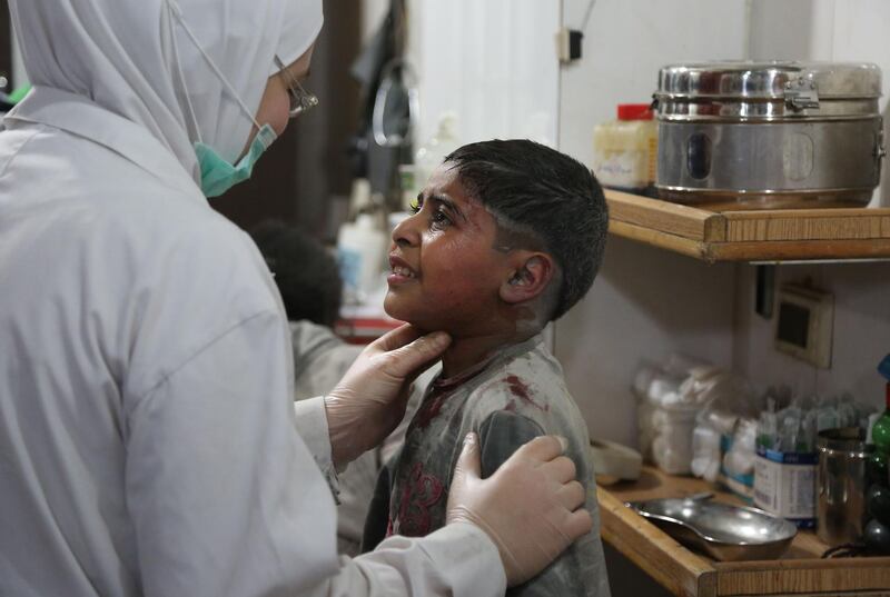 A Syrian boy wounded in a regime air strike on the rebel-held enclave of Eastern Ghouta receives treatment at a make-shift hospital in Kafar Batna.  Ammar Suleiman /  AFP Photo