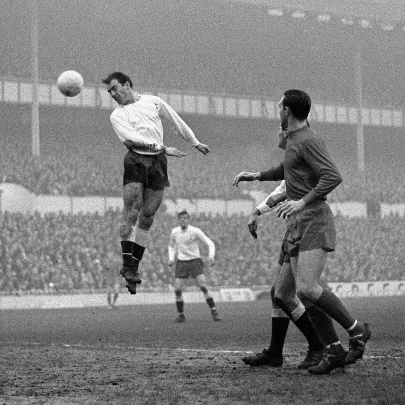 Spurs' Jimmy Greaves (left) leaps for a ball and scores in the match against West Bromwich at White Hart Lane, in 1966. PA