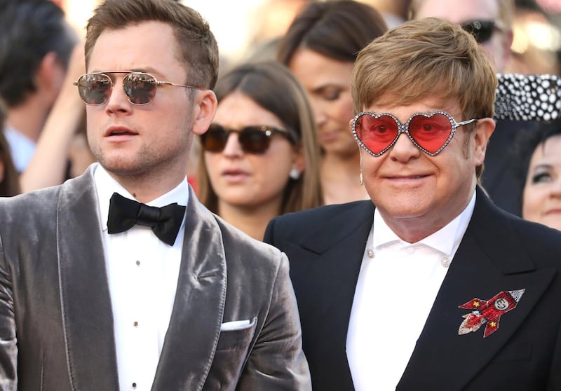 Actor Taron Egerton, left, and singer Elton John pose for photographers upon arrival at the premiere of the film 'Rocketman'. (Photo by Vianney Le Caer/Invision/AP)